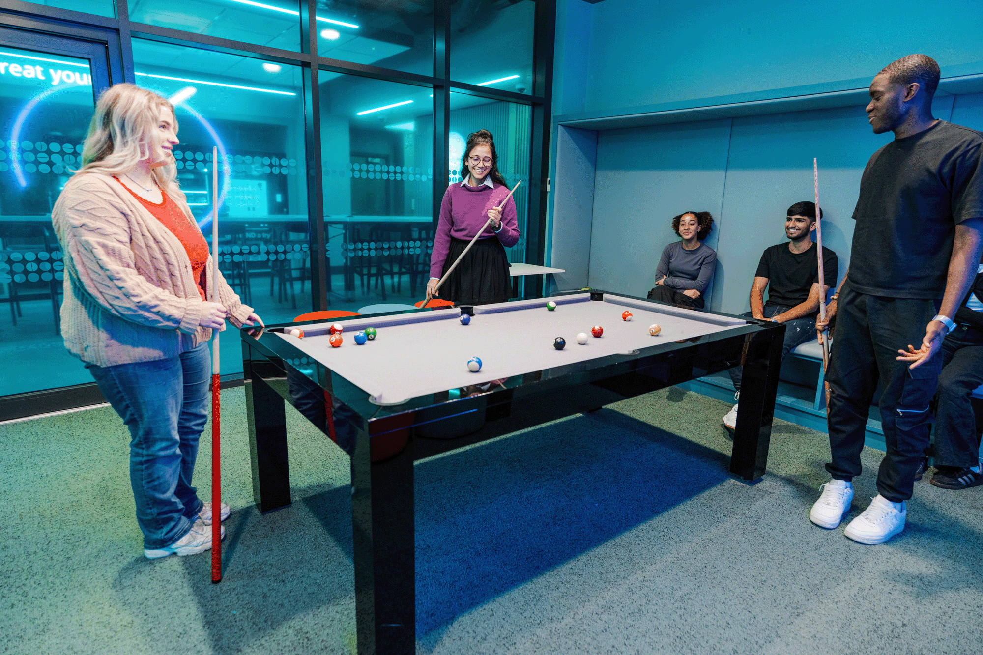 Students enjoying using the pool table at Pritchatts Park
