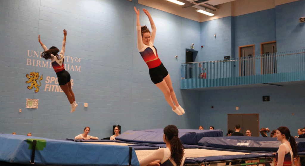 Two students mid-air after jumping on the trampoline in Sport & Fitness.