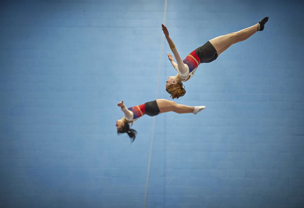 Two students mid-air.