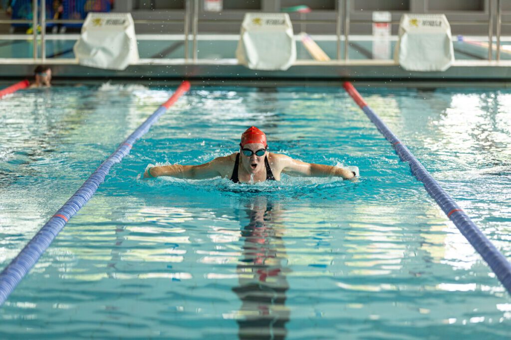 Member doing butterfly stroke in the pool at Sport & Fitness.