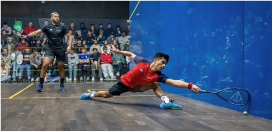 Sanjay hitting ball in Squash court