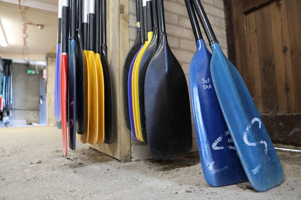 Paddles standing up in the cupboard at the Raymond Priestley Centre.