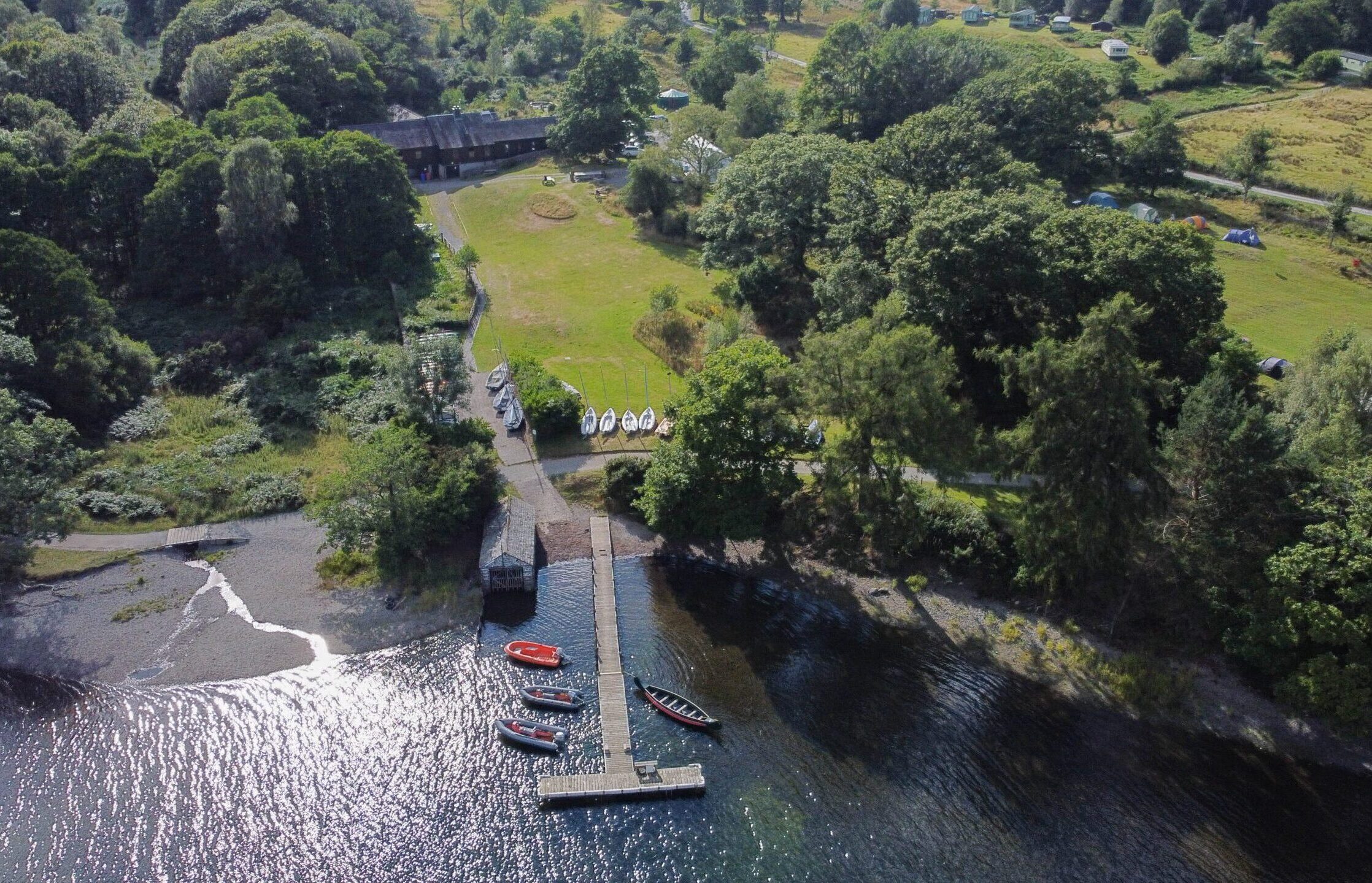 A drone image of the Raymond Priestley Centre, with the lake at the forefront.