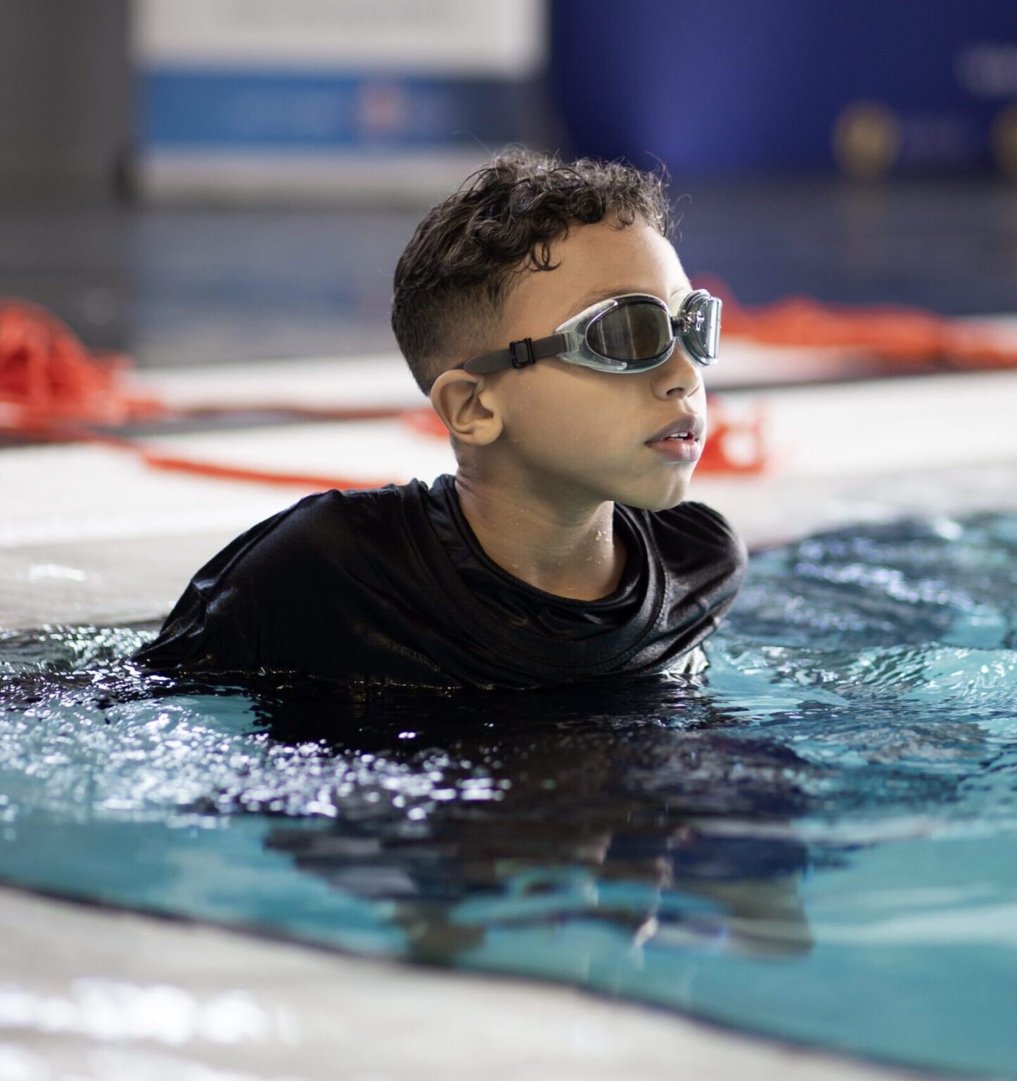 Junior Swimming in the pool during a swimming lesson.