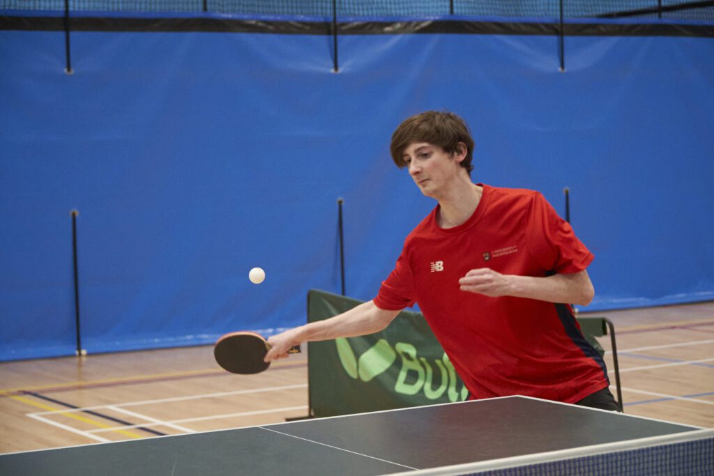 Student playing table tennis