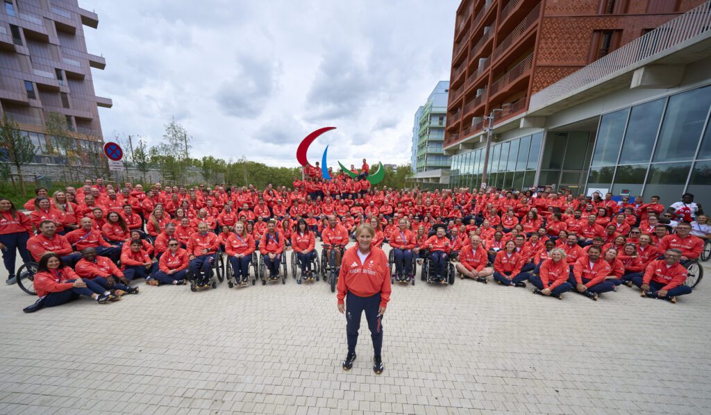Penny Briscoe in front of all the athletes Pennie Briscoe at a table from ParalympicsGB