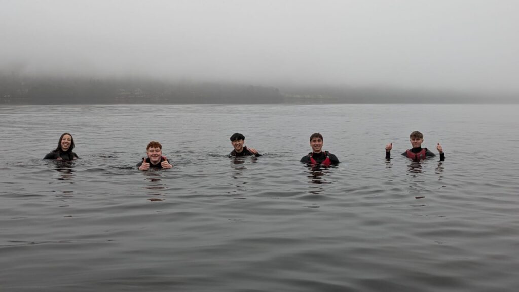 People swimming in a lake, they look happy