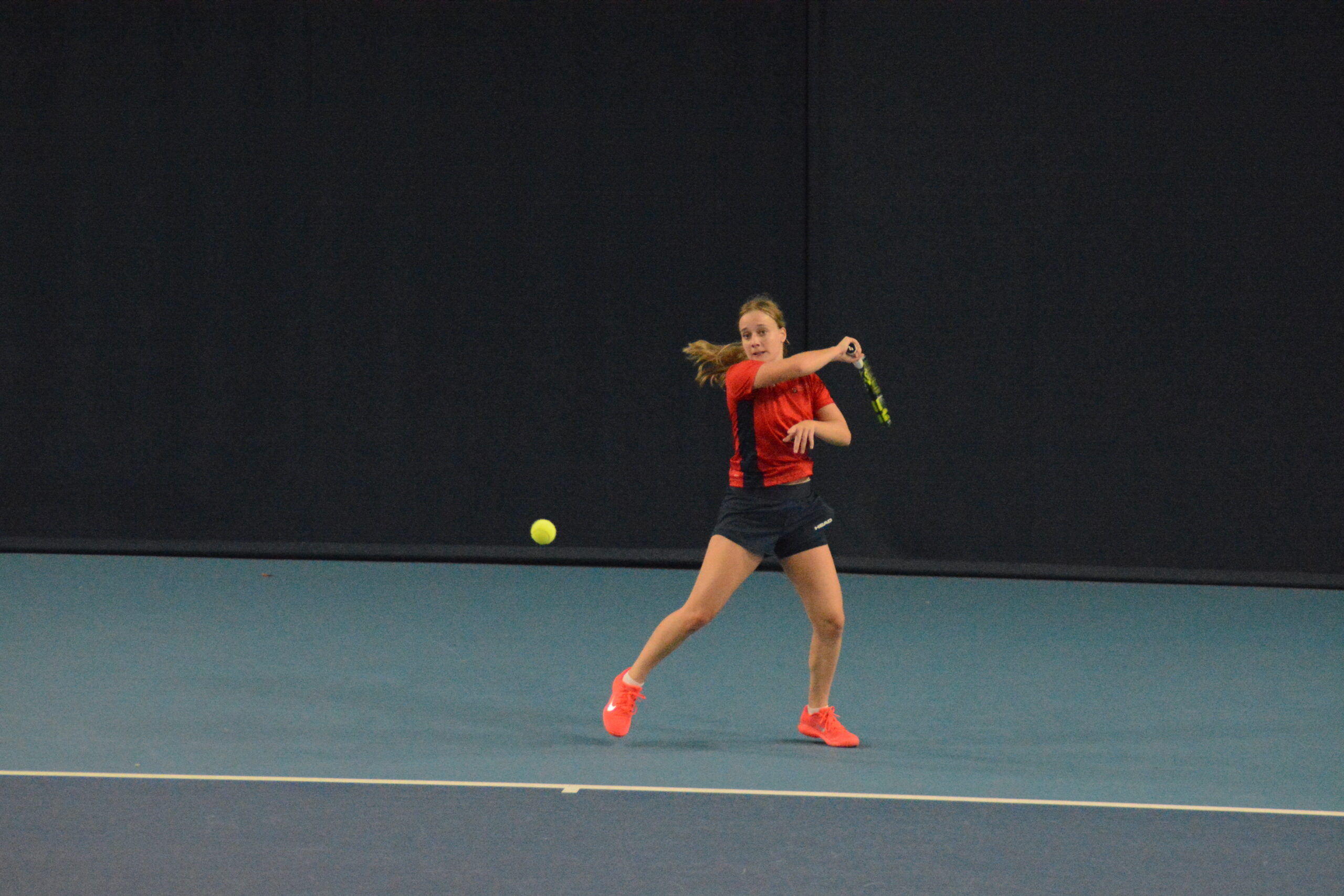 Tennis player returning a shot