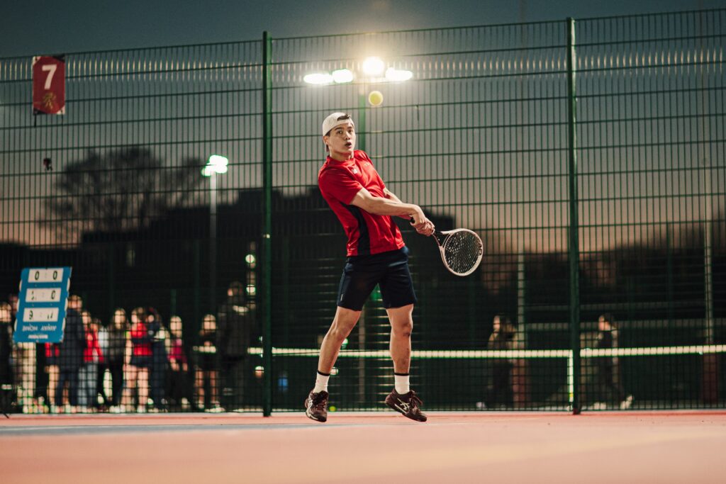 Tennis player performing a backhand on the Tennis Courts on the Edgbaston Campus