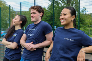Three ambassadors stood on Bournbrook 3G in ambassador t-shirts