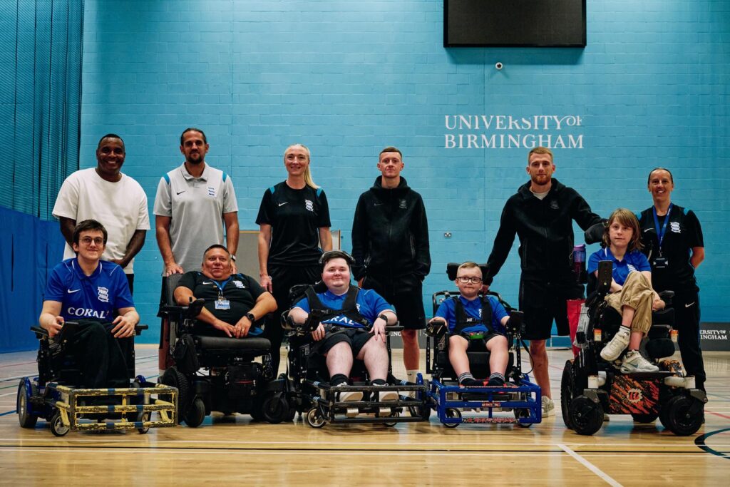 BCFC Powerchair launch phot of people smiling in a group