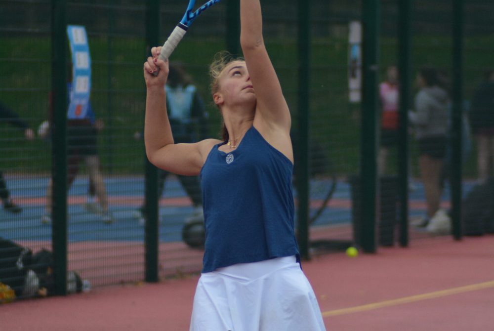 Tennis player serving on the tennis courts on the Edgbaston campus