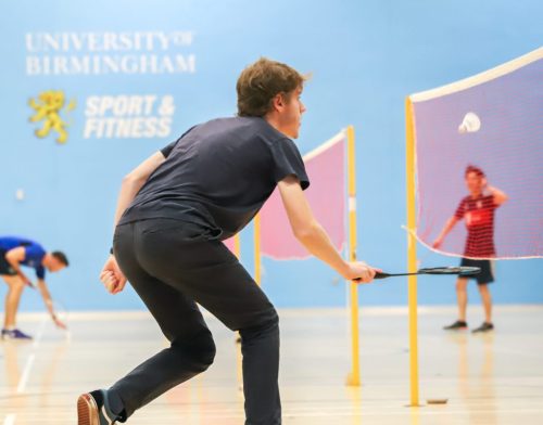 Male Badminton player hitting the shuttlecock